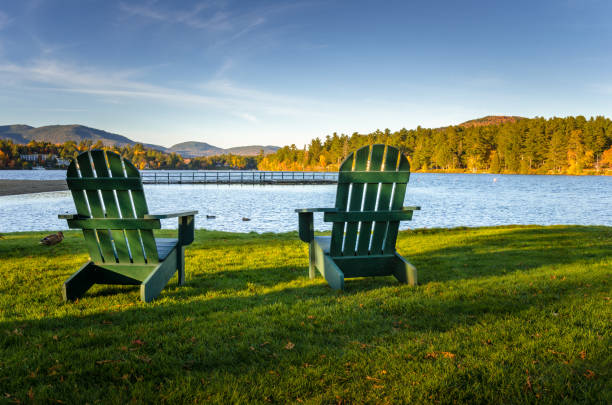 istock Adirondack Chairs Facing a Mountain Lake under Clear Sky 821257454