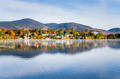 Photo of the Mountain Village of Lake Placid at Sunrise from a Fog Covered Mirror Lake