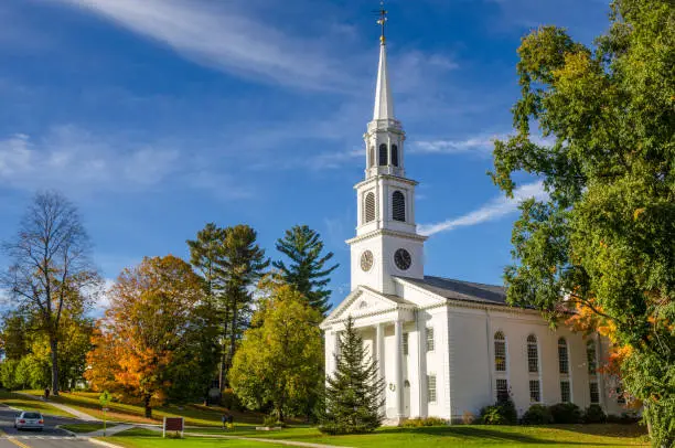 Traditional American White Church with a high Steeple in Williamstown, MA, on a Clear Autumn Day