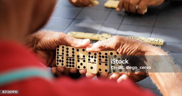 Black Retired Senior Man Playing Domino Game With Friends Stock Photo - Download Image Now