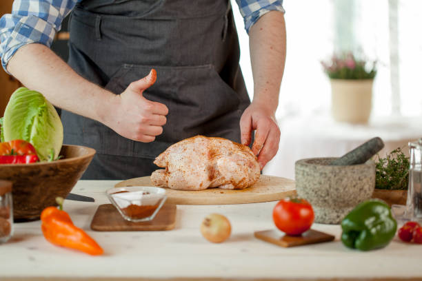 male preparing chicken for cooking