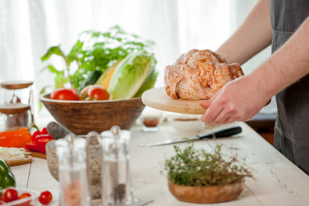 male preparing chicken for cooking