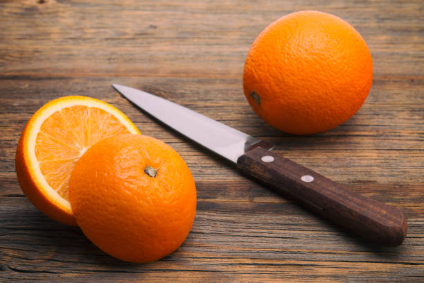 istock Orange on a wooden background 821274592