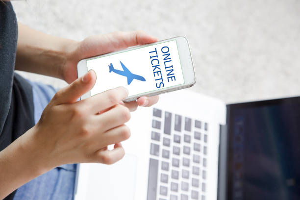 istock Young woman using smart phone. Buying airline tickets on computer. ONLINE TİCKETS 821275358