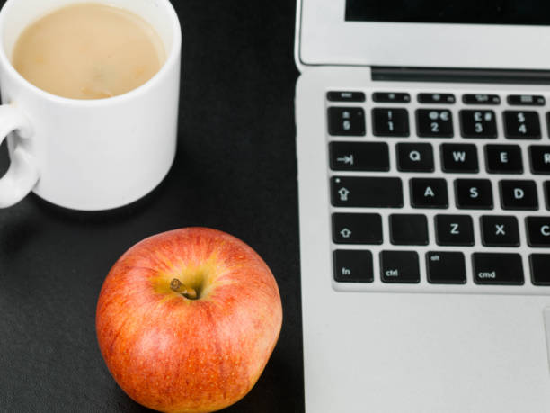 istock Cup of Mushroom Soup With a Red Apple and a Laptop Computer 821275828