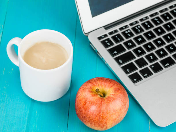 istock Cup of Mushroom Soup With a Laptop Computer And A Red Apple 821275844