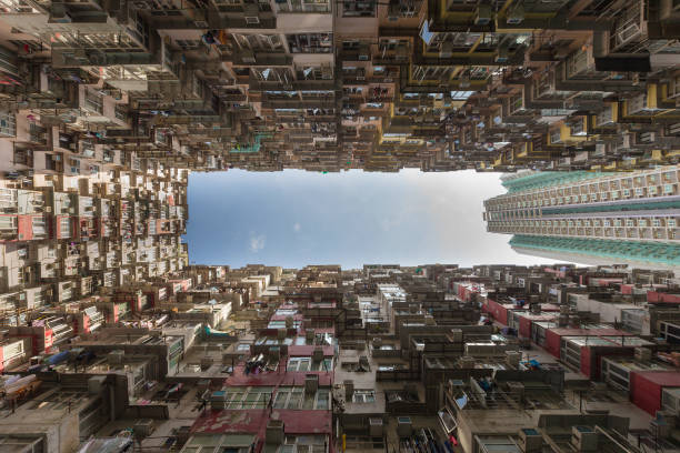 istock Bottom view against blue sky, Apartment crowded residence area 821296096