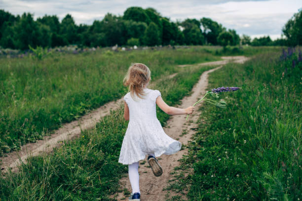 istock Child runs and jumps on a path in the field 821298570