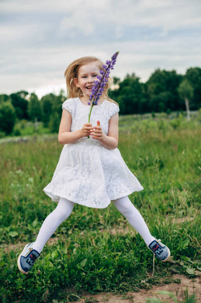 istock Child runs and jumps on a path in the field 821298788