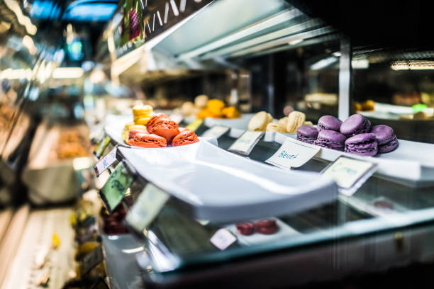 istock Display of many macarons on trays in French bakery 821299390