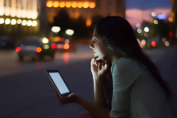 istock Young woman using tablet in a city 821299700