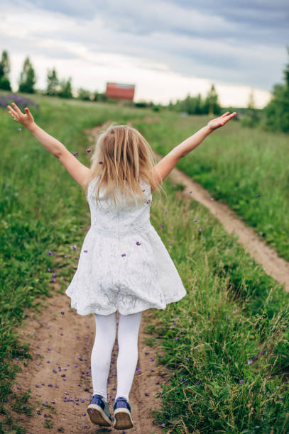 istock Child runs and jumps on a path in the field 821300004