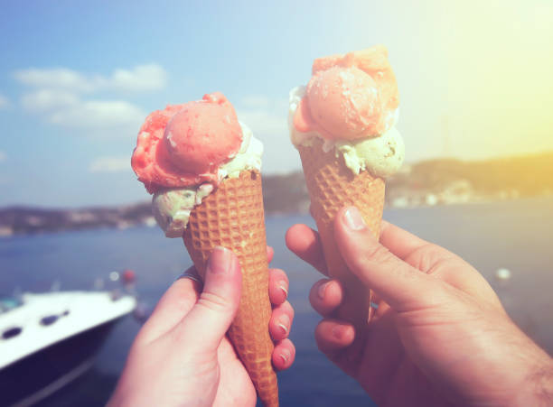 istock Young couple holding ice cream at the sunset. 821303086