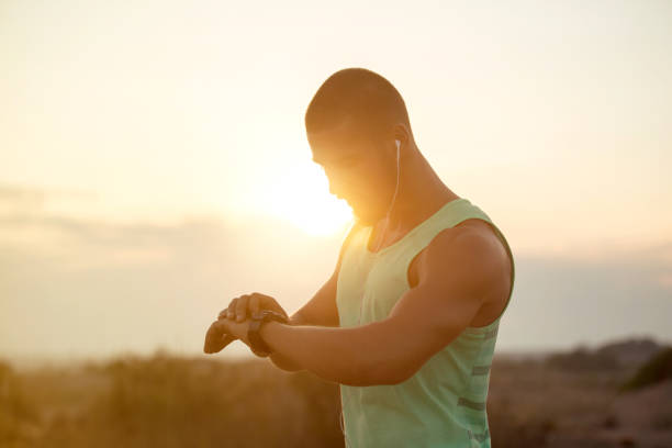 istock Running athlete man looking at smartwatch 821308226
