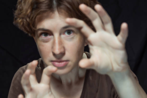 istock Woman scaring someone with her hands 821308692
