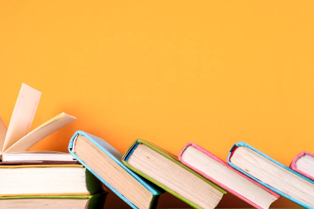 istock Open book, hardback books on bright colorful background. 821308896