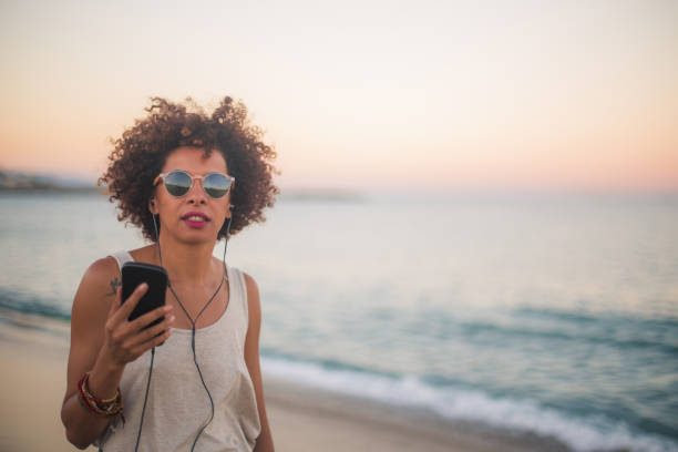 istock Curly woman by the sea 821309582