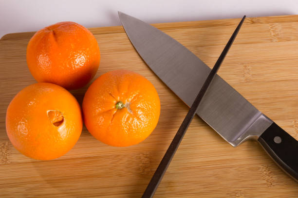 istock Knife and Oranges on Cutting Board with Chopstick 821315180