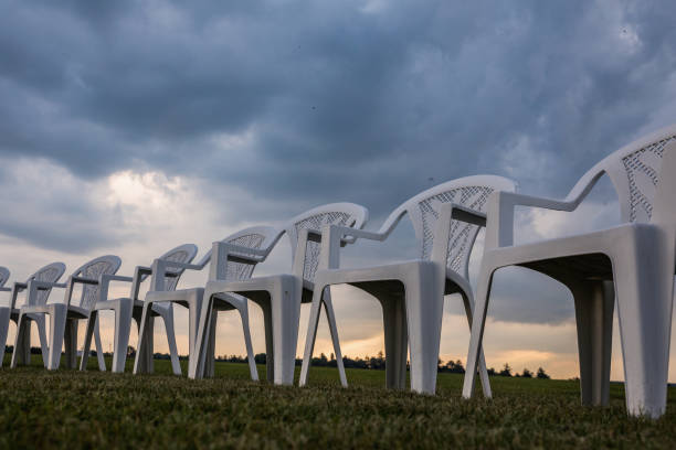 istock White plastic chairs on a meadow arranged in a circle for meditation 821319086