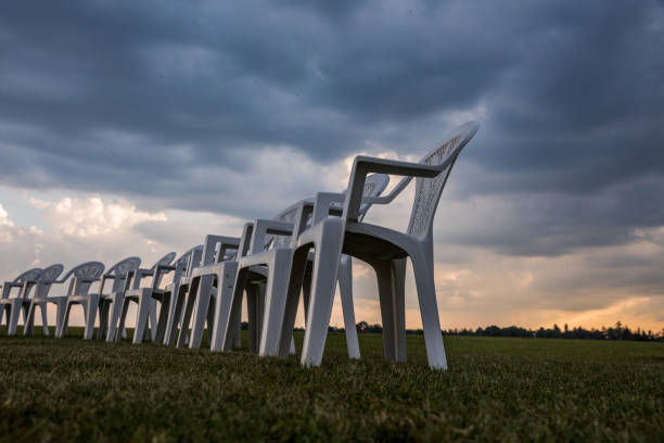 istock White plastic chairs on a meadow arranged in a circle for meditation 821319088