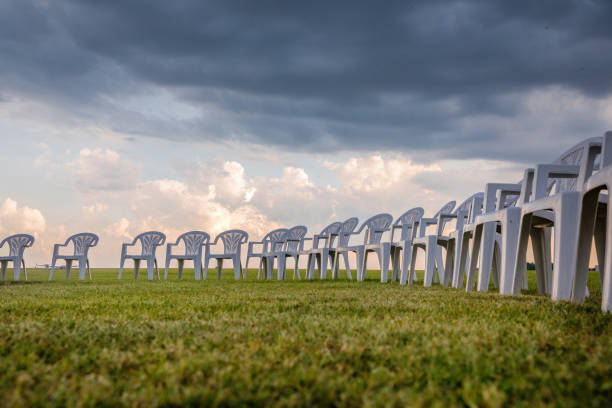 istock White plastic chairs on a meadow arranged in a circle for meditation 821319092