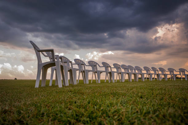 istock White plastic chairs on a meadow arranged in a circle for meditation 821319136