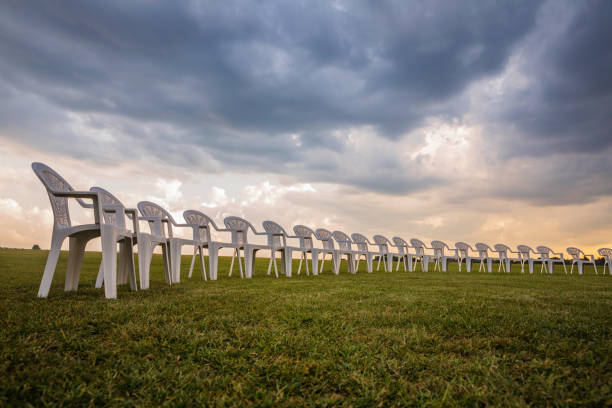 istock White plastic chairs on a meadow arranged in a circle for meditation 821319140