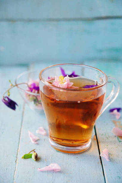 istock cup of tea with chamomile flowers on rustic wooden background 821330920