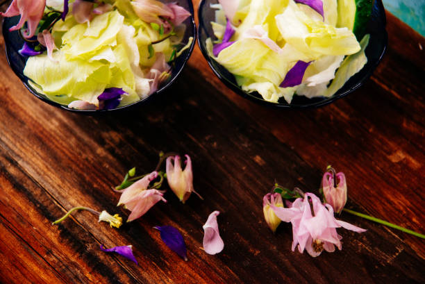 istock Edible flowers salad in a plate on blue wooden table with fork 821331402