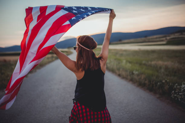 istock Woman holding US flag 821333620