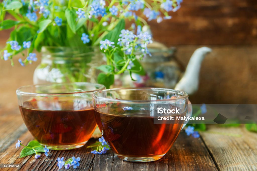 Tea and forget-me-nots Afternoon Tea Stock Photo