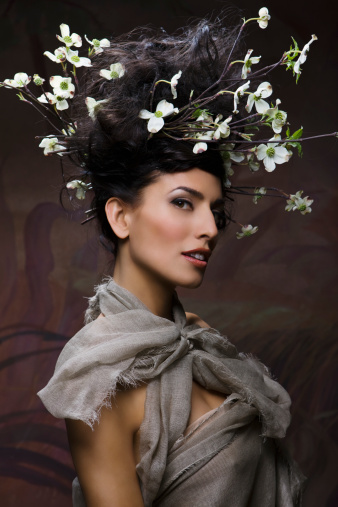 Beautiful woman with flowering twigs in hair