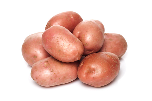 Pile of red potatoes isolated on white background