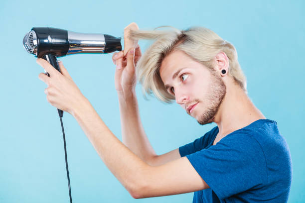 istock Trendy man with hair dryer 821359698