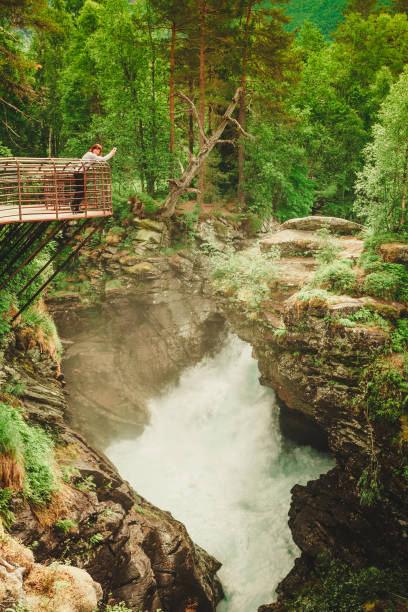 istock Tourist with camera on Gudbrandsjuvet waterfall, Norway 821359948