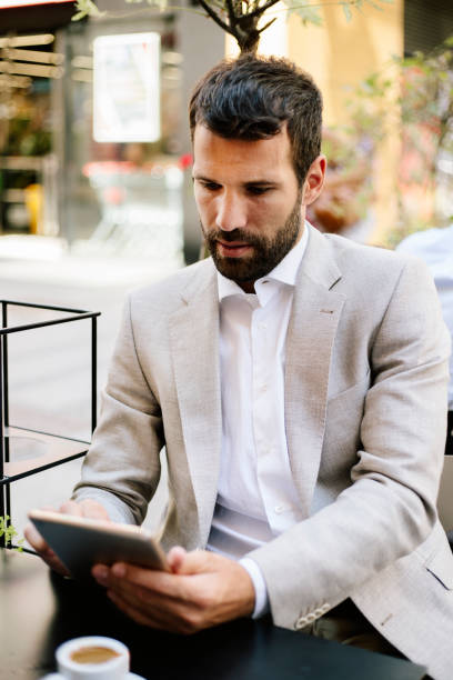 istock Young businessman in cafe bar using tablet 821362612