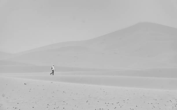 istock Woman walking desert 821366060