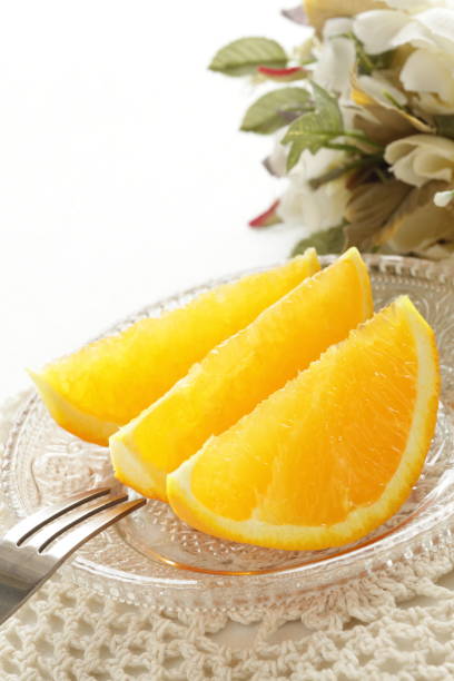 istock cut orange on glass dish 821369786