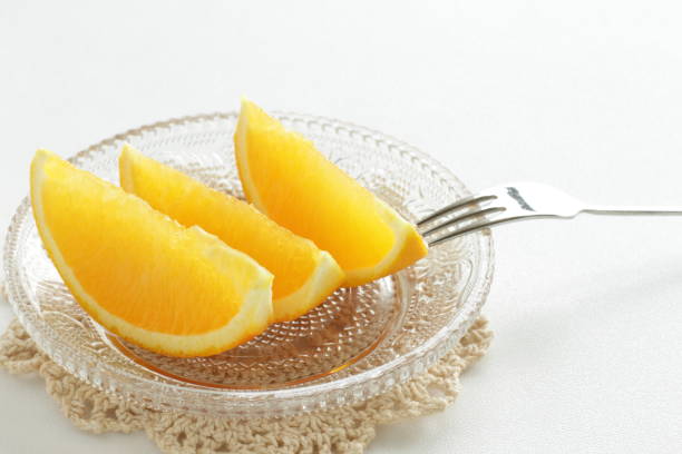 istock cut orange on glass dish 821369888
