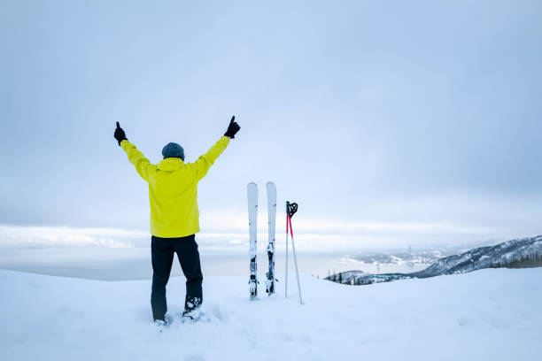 3d white skier with goggles, scarf, wool cap, ski boots and gloves. 3d image. Isolated white background.