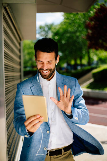 istock Young businessman having video call outdoors 821373022