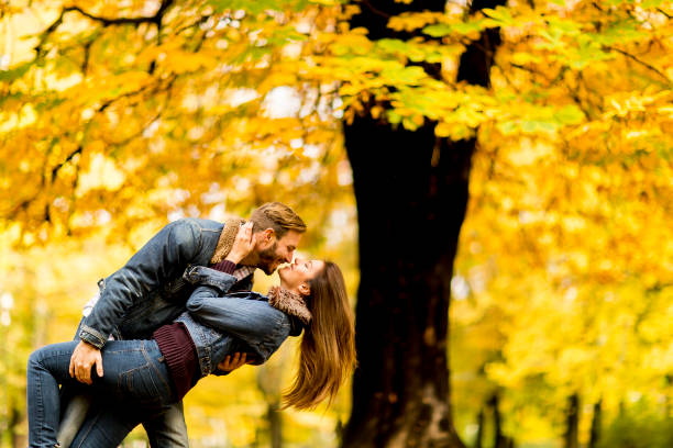 istock Smiling couple hugging in autumn park and having fun 821375826