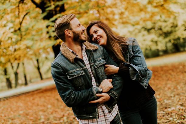 istock Smiling couple hugging in autumn park 821375846