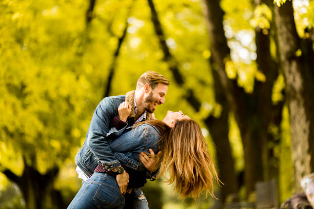 istock Smiling couple hugging in autumn park 821375850