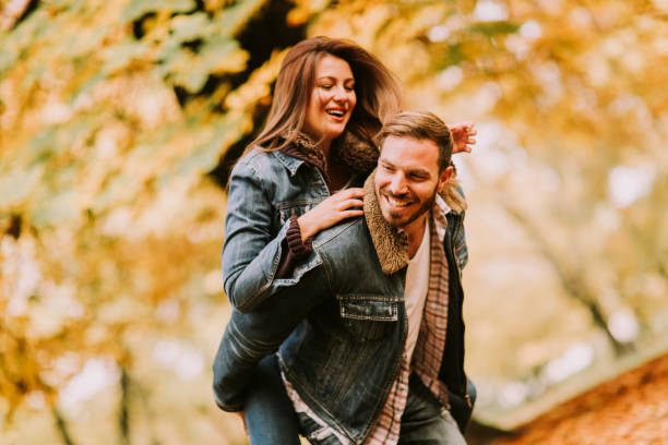 istock Loving couple in autumn park 821375892