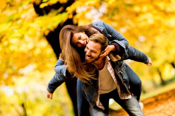istock Young loving couple having fun in the autumn park 821375904