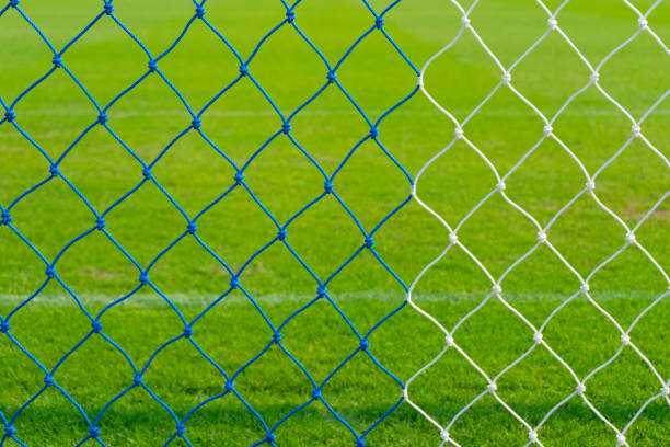 istock Soccer goal net against green background 821376110