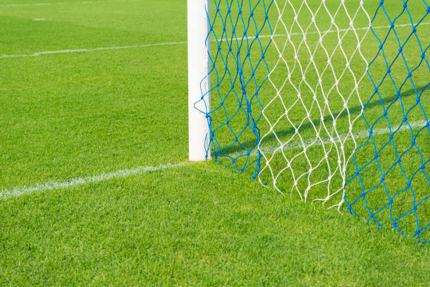 istock Soccer goal net against green background 821376124