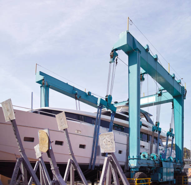 istock Crane lifting boats at harbor 821379064
