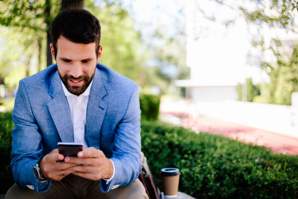 istock Businessman typing message outdoors 821379646
